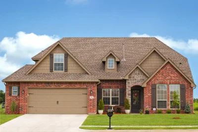 A brick house with multiple windows showing exterior view, ideal for brick home window replacement assessment